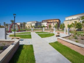 a park with a playground and buildings in the background