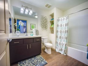 a bathroom with a sink toilet and shower