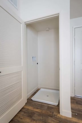 a small bathroom with a shower in the corner of the room