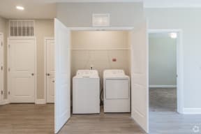 a laundry room with two washer and dryers in it