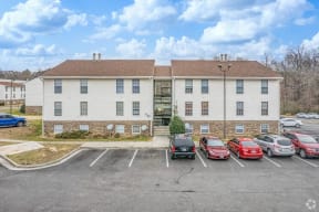 a large white building with cars parked in front of it