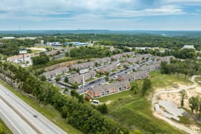 an aerial view of a city with houses and a highway