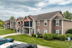 a row of houses with cars parked in front of them