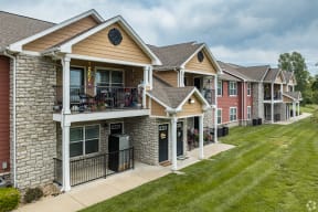 a row of houses with balconies and a yard