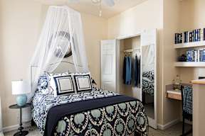 a bedroom with a bed and a closet