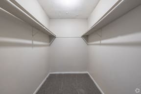 an empty room with white walls and shelves in it