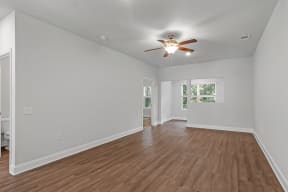 a bedroom with hardwood floors and a ceiling fan