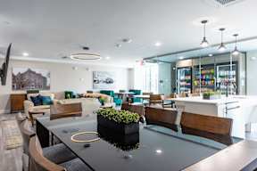 A modern dining area with a glass table and chairs.