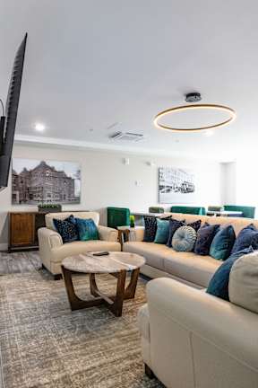 A living room with a white couch and a coffee table.