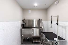A stainless steel kitchen with a large pot on the stove.