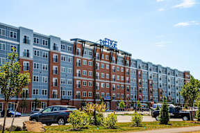 A large apartment complex with a blue sign on the side.