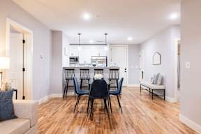A dining room with a table set for six.