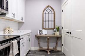 A kitchen with a table and a window.