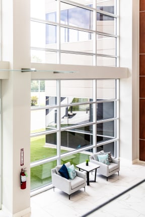 a living room with two couches and a coffee table in front of a large window
