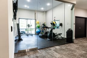 a home gym with a treadmill and exercise balls