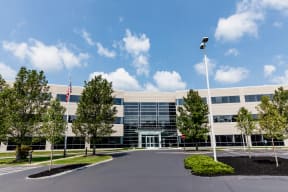 an office building with an american flag in front of it