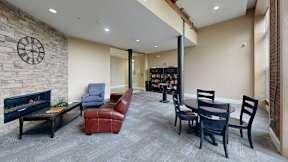 A living room with a fireplace and a bookshelf.
