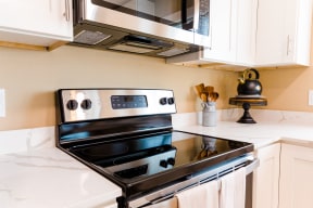 a kitchen with a stove and microwave in a 555 waverly unit