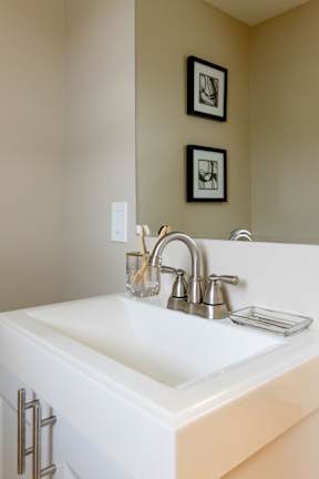 A white sink with a silver faucet and a soap dish.