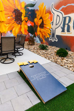 a yoga mat on the grass in a backyard with a table and chairs