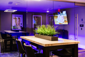 a dining room with a table with a plant on top of it