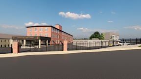 A building with a black fence in front of it.