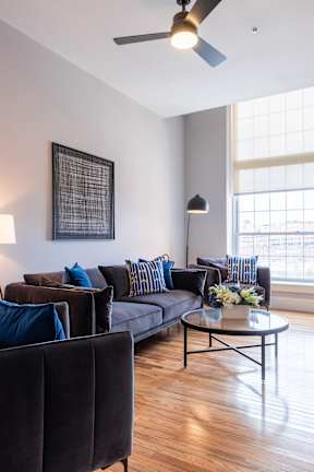 A living room with a couch, chairs, and a coffee table.