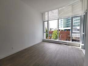 A room with a large window overlooking a cityscape.