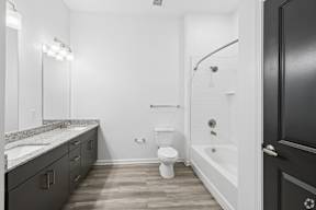 A bathroom with a toilet, sink, and bathtub.