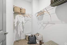 A white bathroom with a towel hanging on a rack.