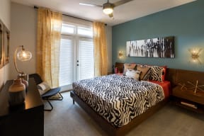a bedroom with a bed with a zebra print comforter