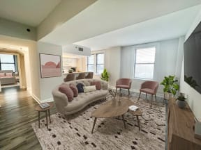 a living room with a couch and chairs and a rug