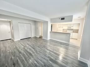 an empty living room and kitchen in a new home