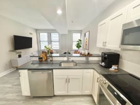 a kitchen with white cabinets and a counter top