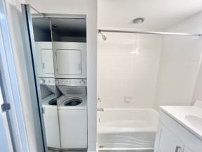 a small bathroom with a washer and dryer in it