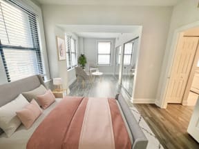 a bedroom with a bed and a living room with a dining room