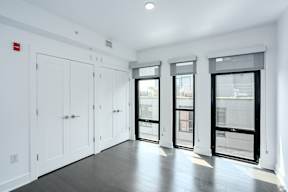 Primary bedroom with floor to ceiling windows