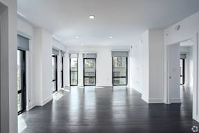 an empty living room with white walls and glass doors