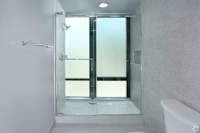 Primary Bedroom bathroom with a glass shower door in a white bathroom