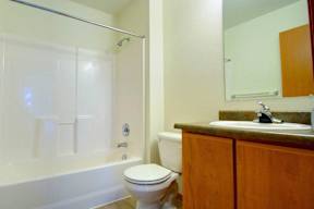 A white toilet sits next to a sink in a bathroom.