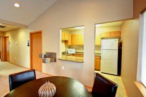 A modern kitchen with a dining table and chairs.