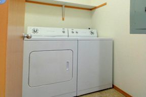 A white dishwasher is in a small kitchen.