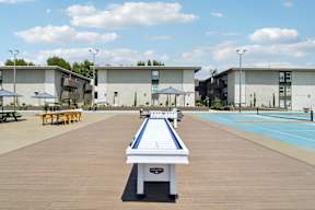A shuffleboard court is in the middle of a resort area.