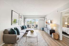 A living room with a grey couch and a white coffee table.