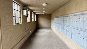 A long hallway with a series of lockers on the wall.