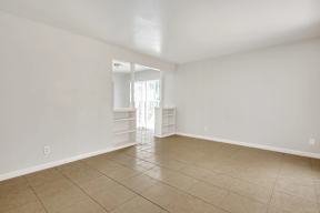 Empty room with tiled floor and white walls.