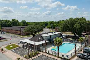 A large building with a pool in front of it.