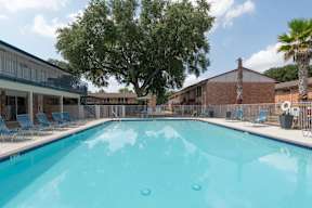 A large swimming pool with a blue tinted water.