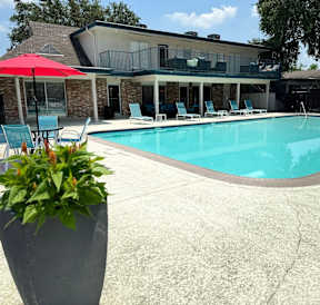 A house with a pool and patio furniture.
