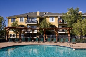 a large swimming pool in front of a large house